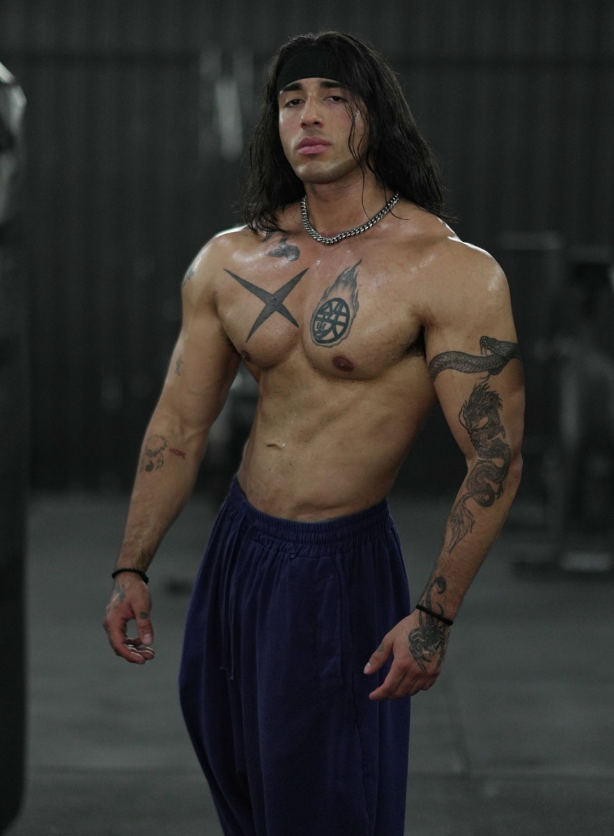 The coach is posing at the gym.